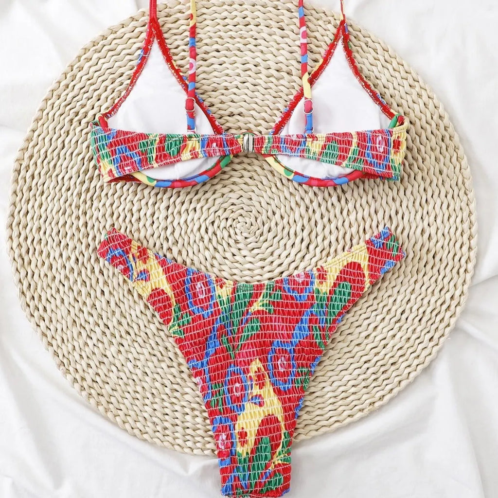 Red floral patterned women's underwire triangle bikini top and briefs set on a white background.