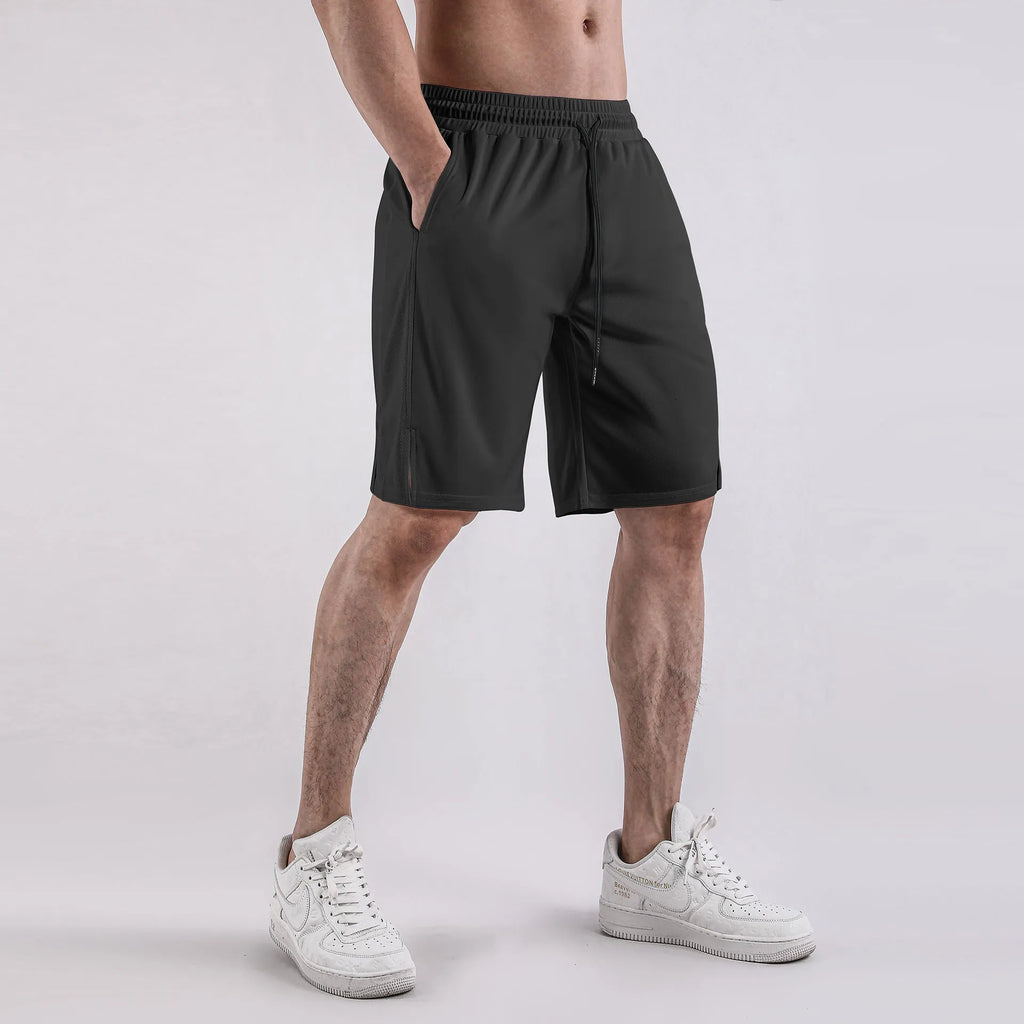 Man wearing loose black quick-dry polyester fitness shorts with an elastic waistband.