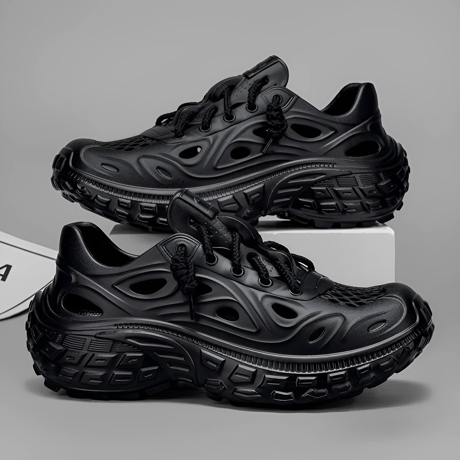Men's black EVA sandals with thick sole, covered heel, and breathable hollow-out upper design.