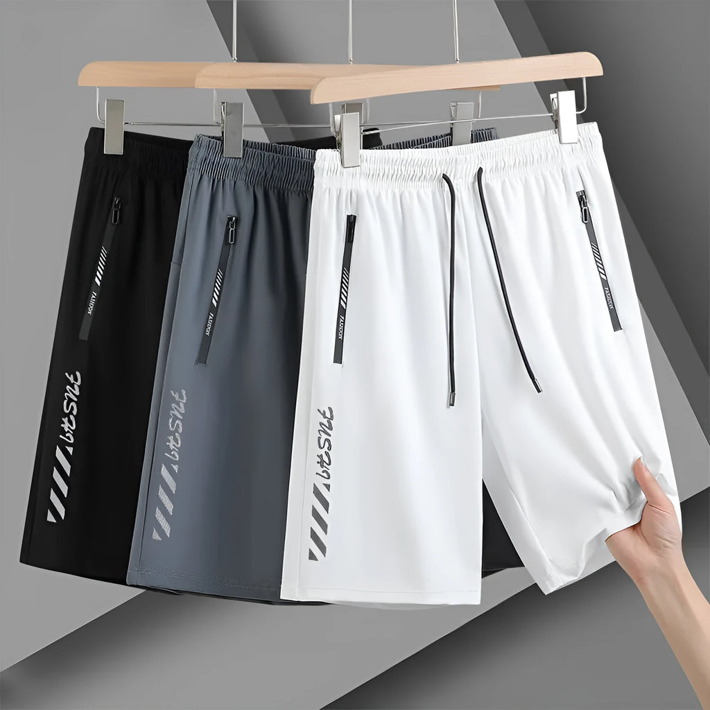 Man wearing black loose-fit quick-dry nylon sports shorts.