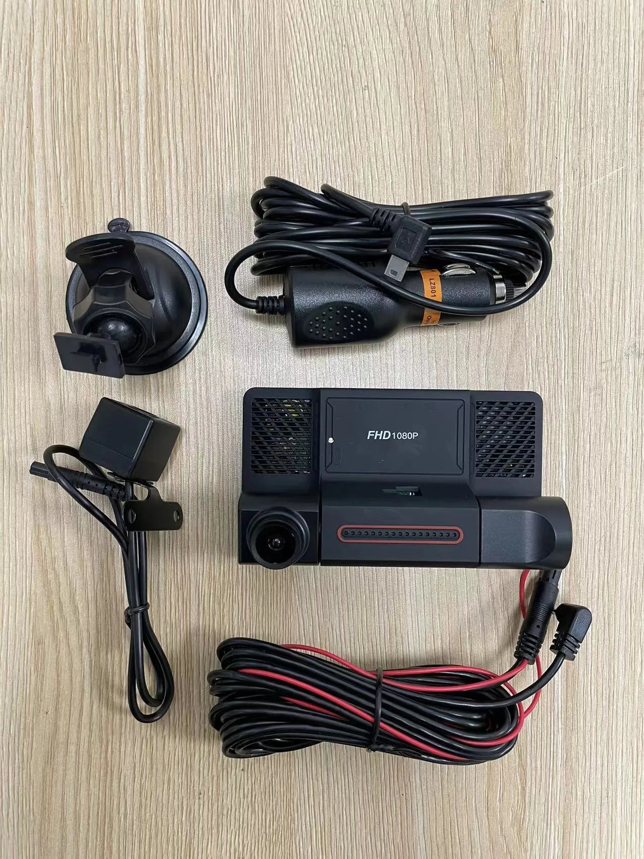 Black three-lens dash cam with 4-inch touchscreen display for front and rear vehicle recording