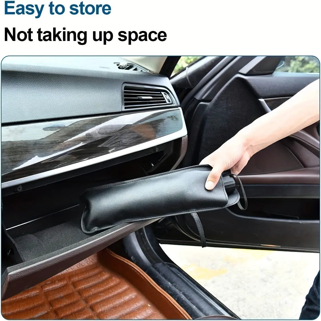 Open foldable car windshield sunshade umbrella placed against a car windscreen.