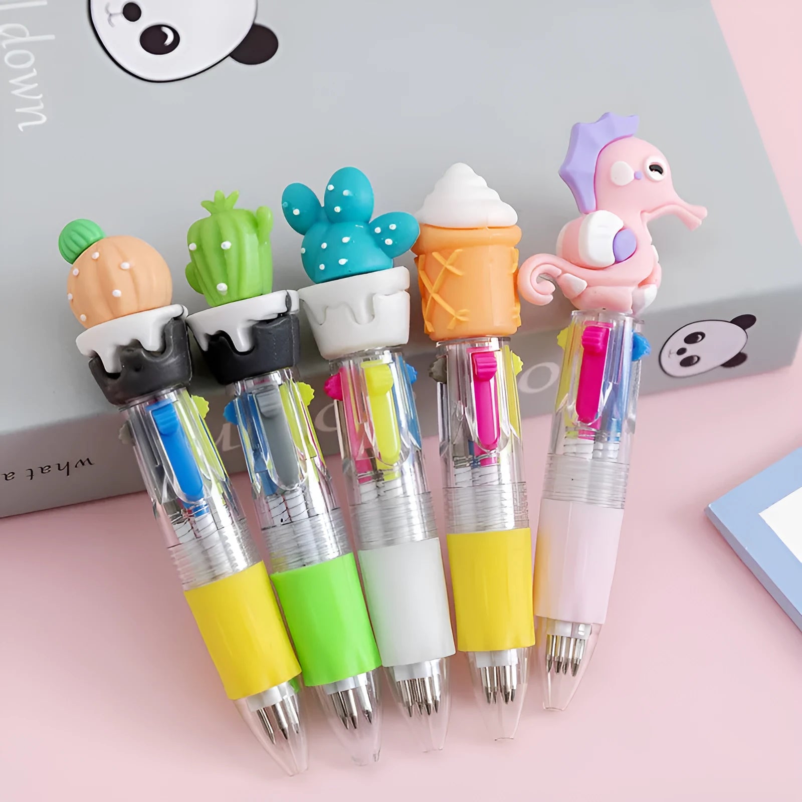 Cute cartoon-themed four-colour press-type ballpoint pen with a silicone grip and 0.7mm tip.