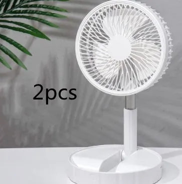 Black telescopic folding fan extended to full height on a desk, showing mechanical controls and compact folded size inset.