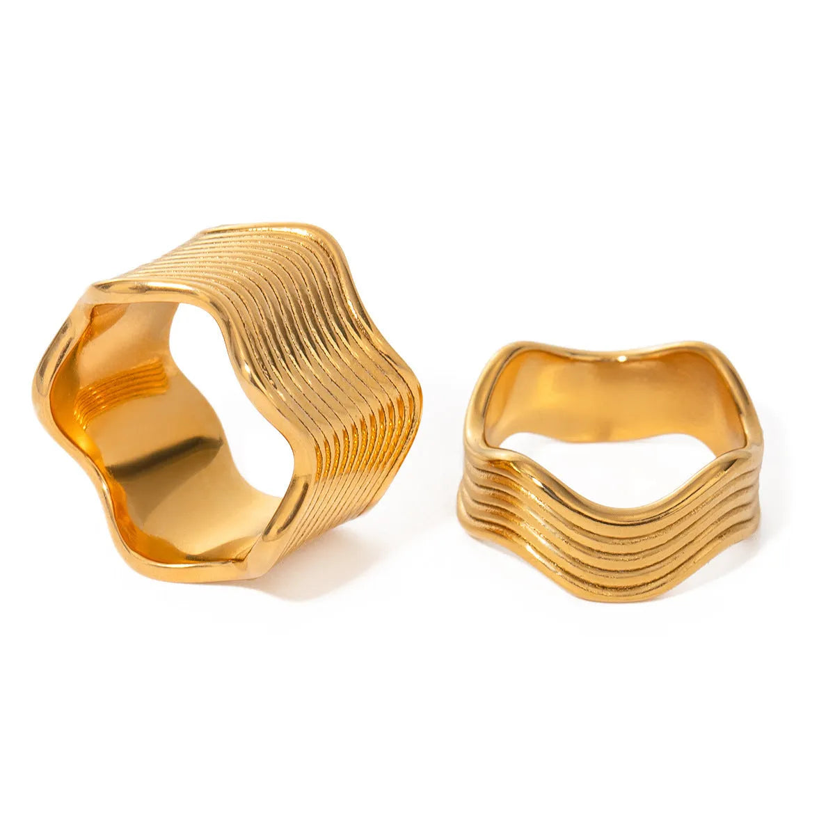 Stainless steel ring with a geometric wave pattern on a wide band, showing two colour options.