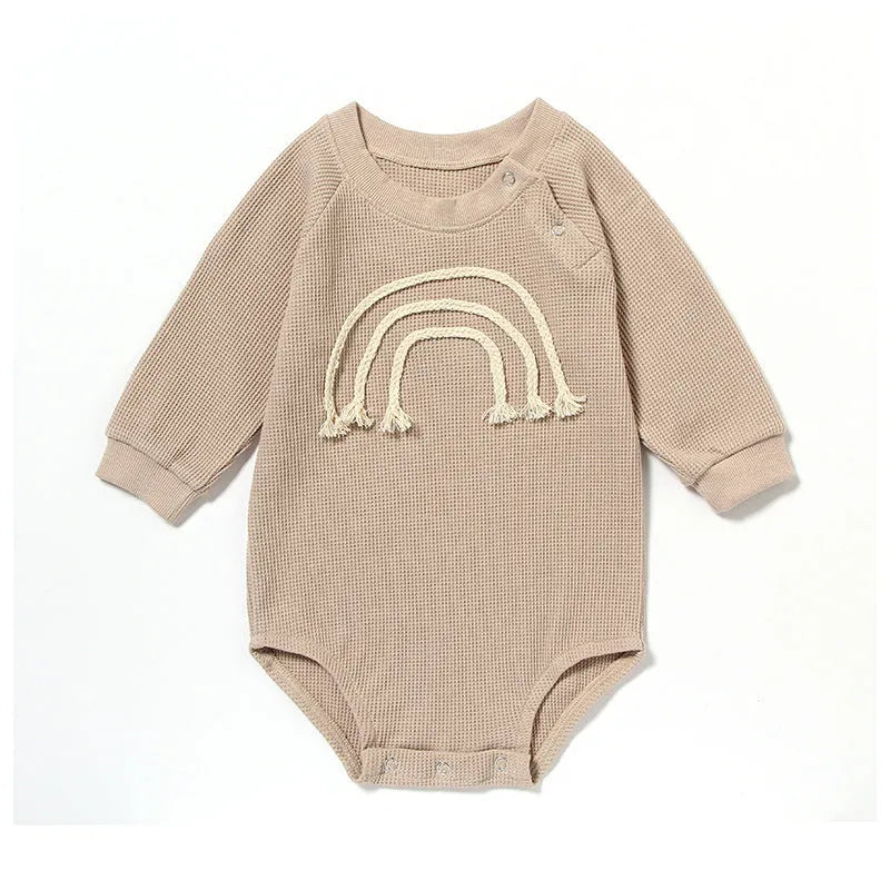 Long sleeve waffle cotton baby romper in neutral colour on hanger