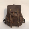 Brown men's leather backpack with an air-pillow belt system on the back.