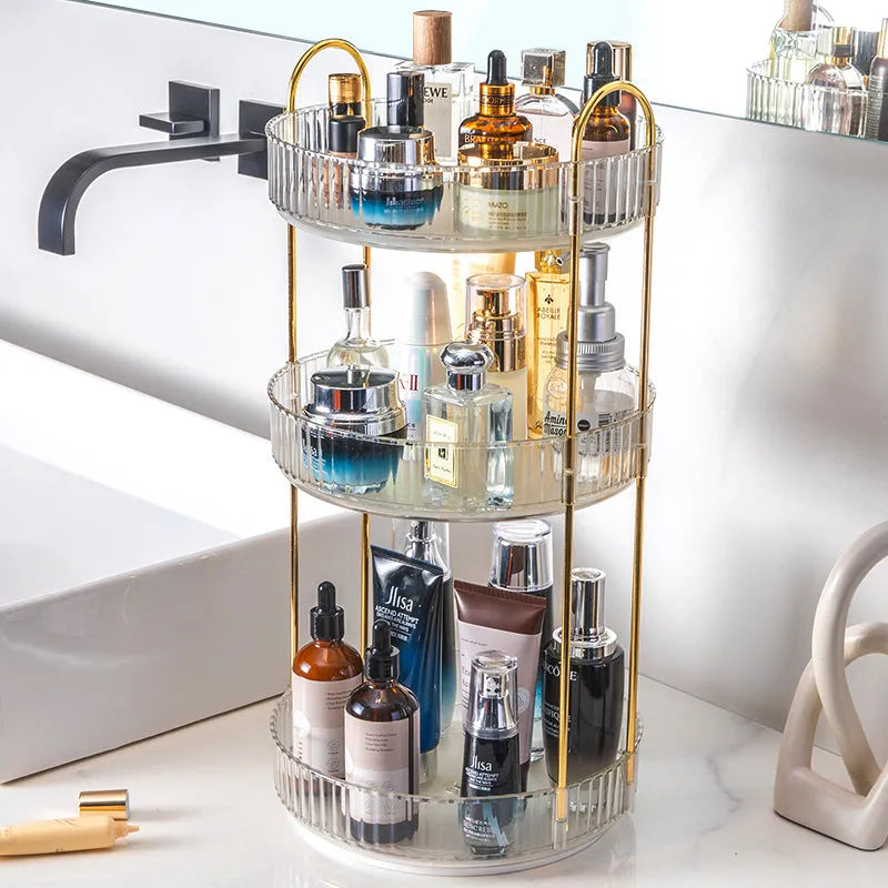 Three-layer rotating bathroom cosmetics storage rack in green on a desktop, with bottles on each tier.