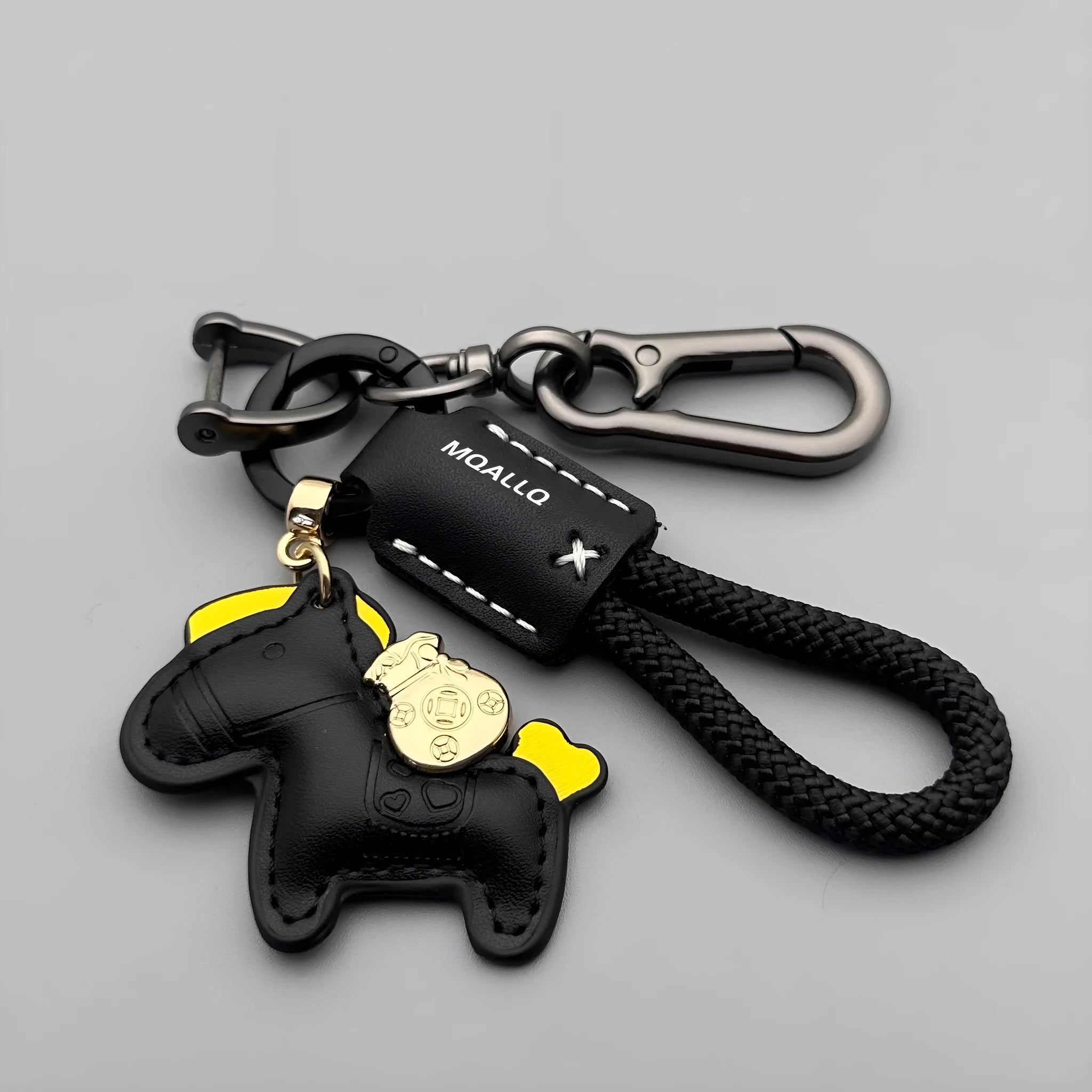 Handmade brown cowhide key ring pendant with a zinc alloy pony buckle on a green flanelle rope.