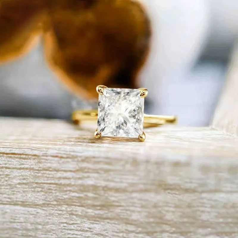 A geometric 925 sterling silver ring with a round zirconium detail, shown in silver, gold, and rose gold colour options.