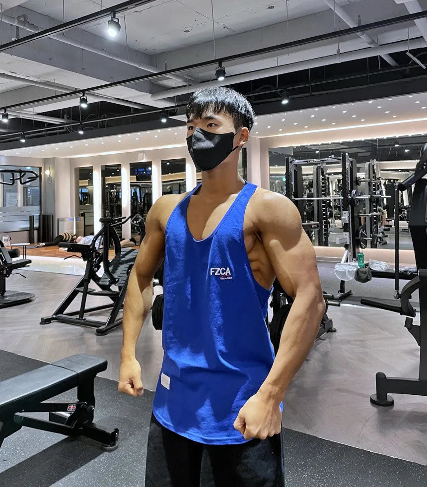 Men's white cotton fitness vest for summer running and gym training on a plain background