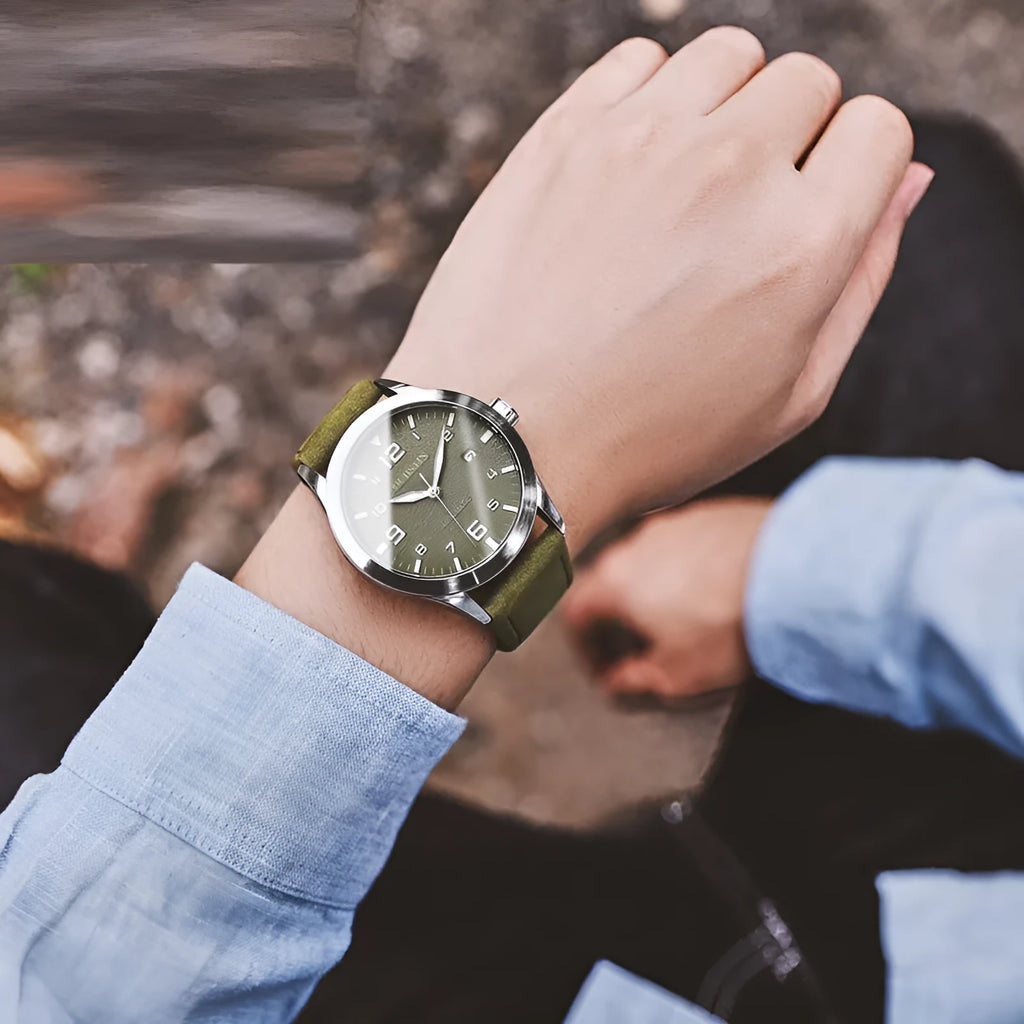 Men's automatic mechanical watch with leather strap on wrist, showing silver case and army green dial option.