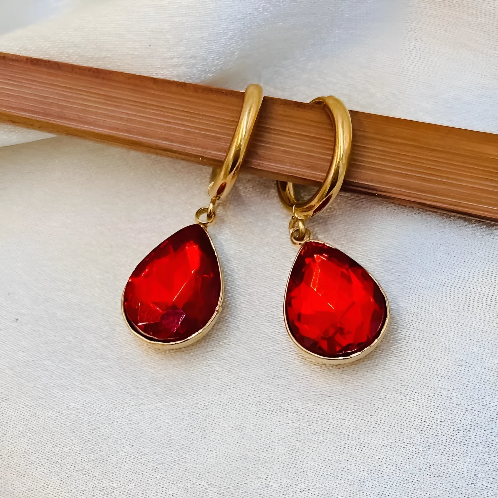 Hand-carved glass water drop earrings with geometric Saturn design in various colours