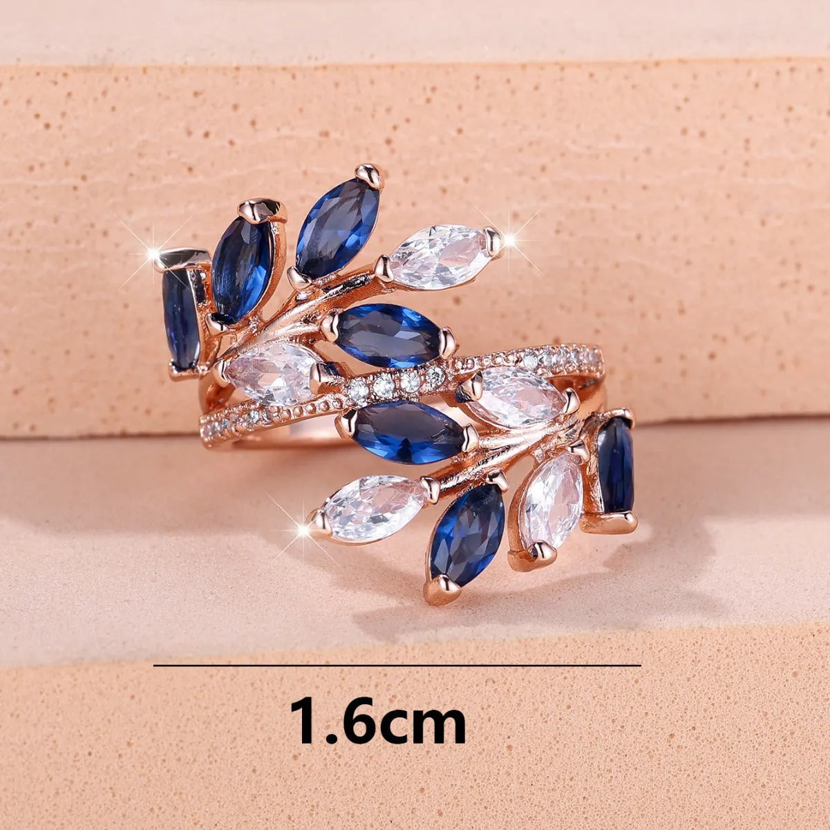 Copper leaf-shaped ring with horse eye design and zircon stones on a finger, showing adjustable opening.