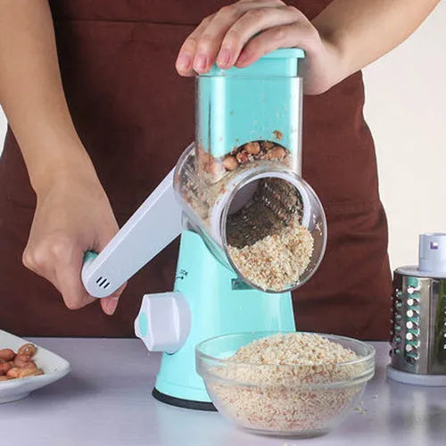 Blue manual mandoline vegetable slicer with stainless steel blade on a kitchen counter.