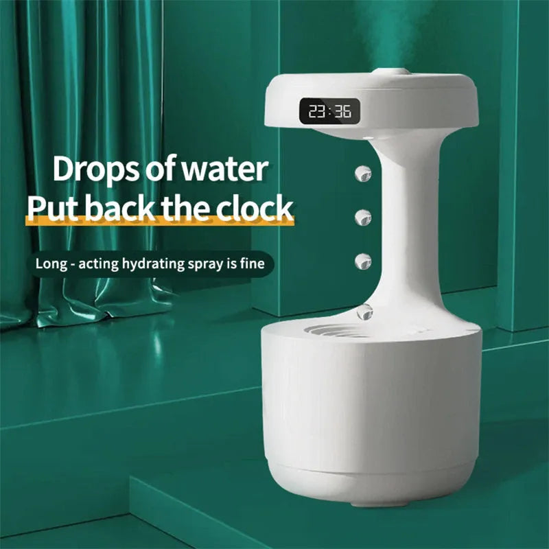 White columnar anti-gravity humidifier with LED clock display emitting mist on a wooden desk.