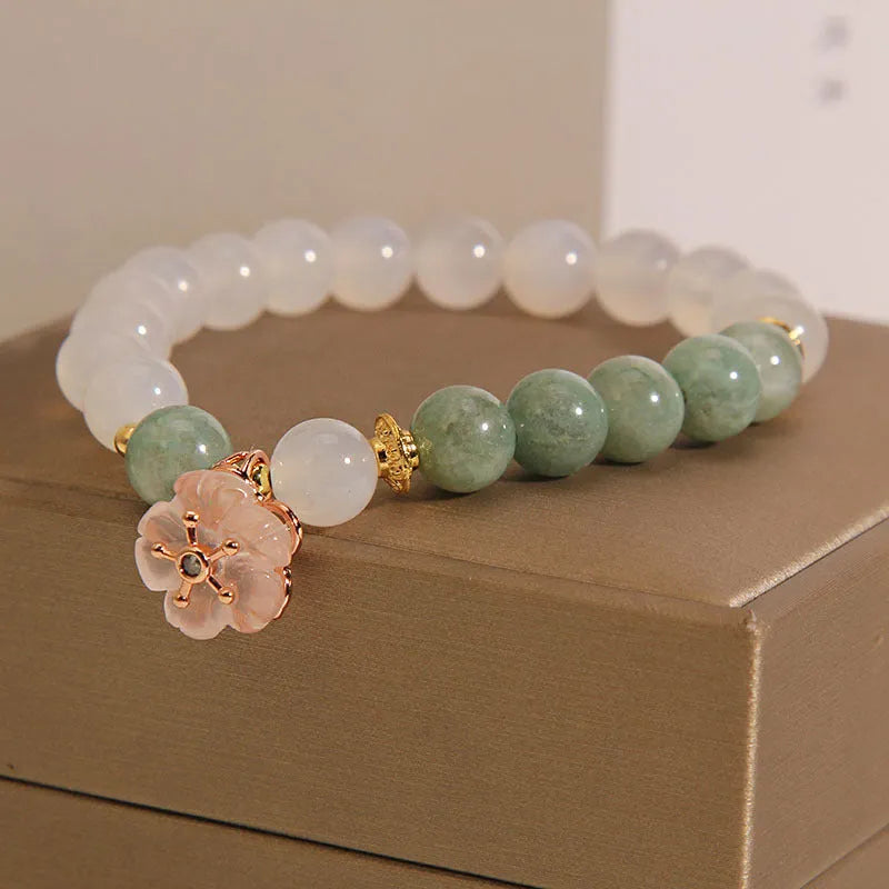 Jade floral bracelet with white agate jadeite stone and pink flower details on wrist