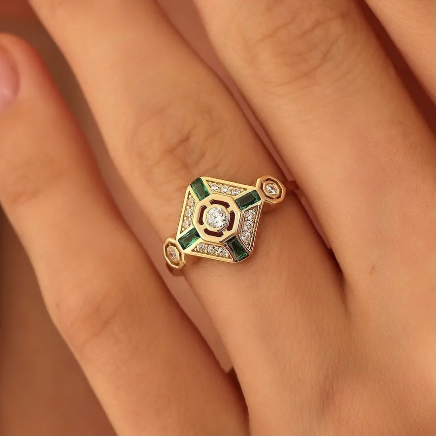 Square geometric emerald diamond ring for women with a green zircon stone on a finger.