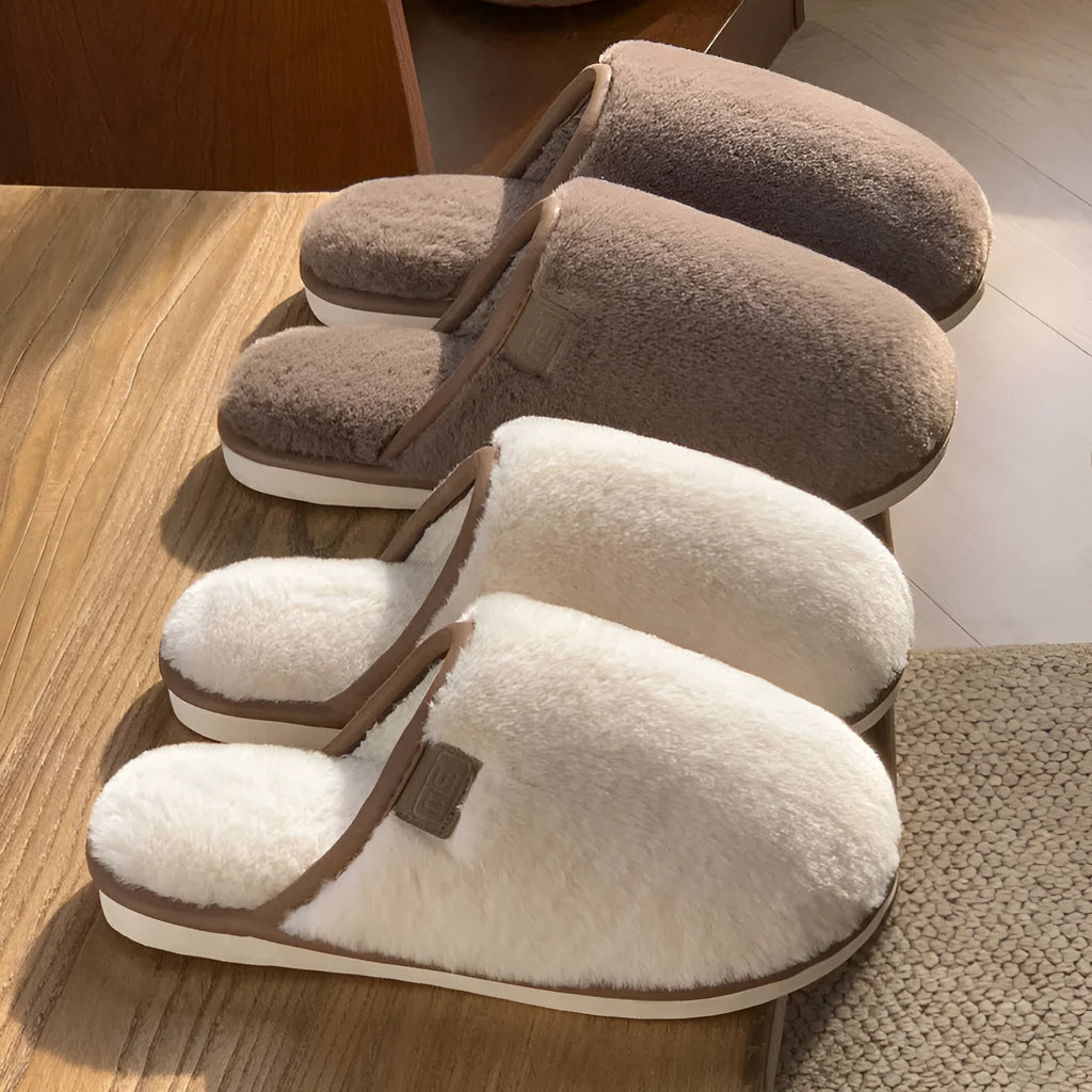Blue plush PVC winter slipper with non-slip sole and car stitching detail on a wooden floor.