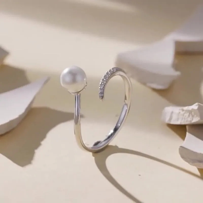 S925 sterling silver adjustable open loop ring with a natural shell pearl on a white background.