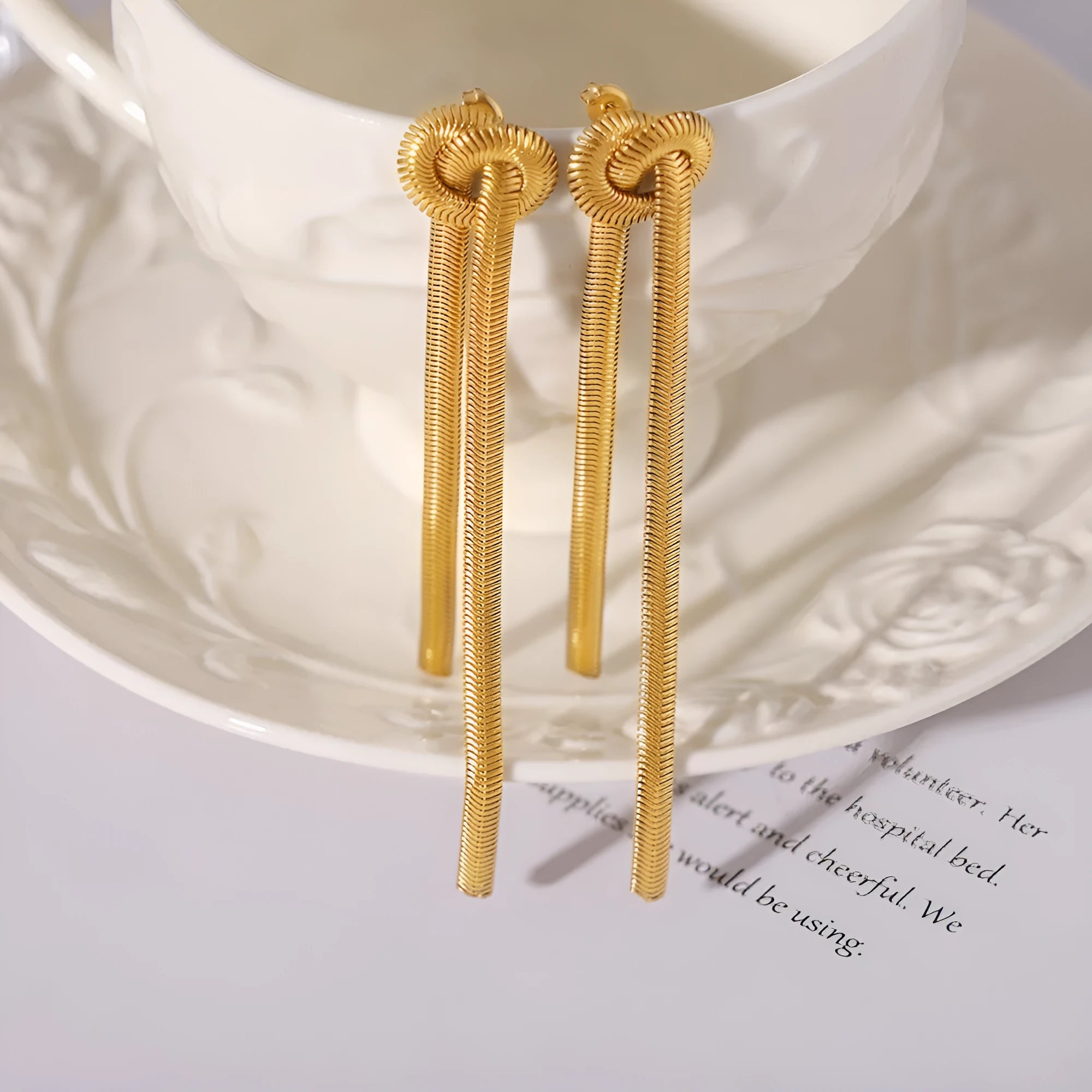 Gold-plated titanium steel necklace with knotted tassel pendant and matching earrings