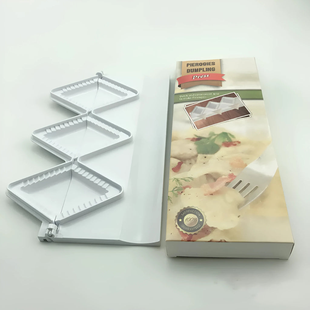 Pure white plastic dumpling maker 28.5 cm long on a kitchen countertop