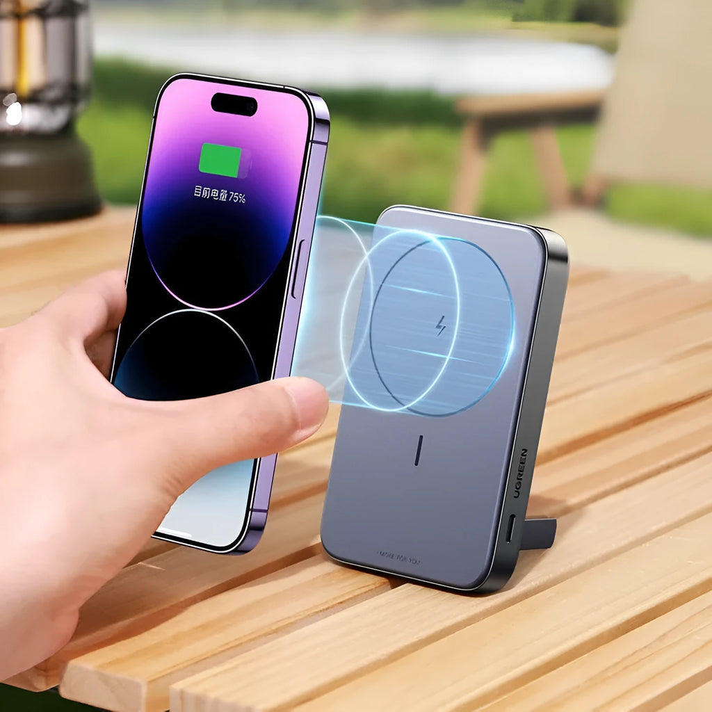 Small black portable magnetic bracket power bank with 10000mAh capacity on a table.