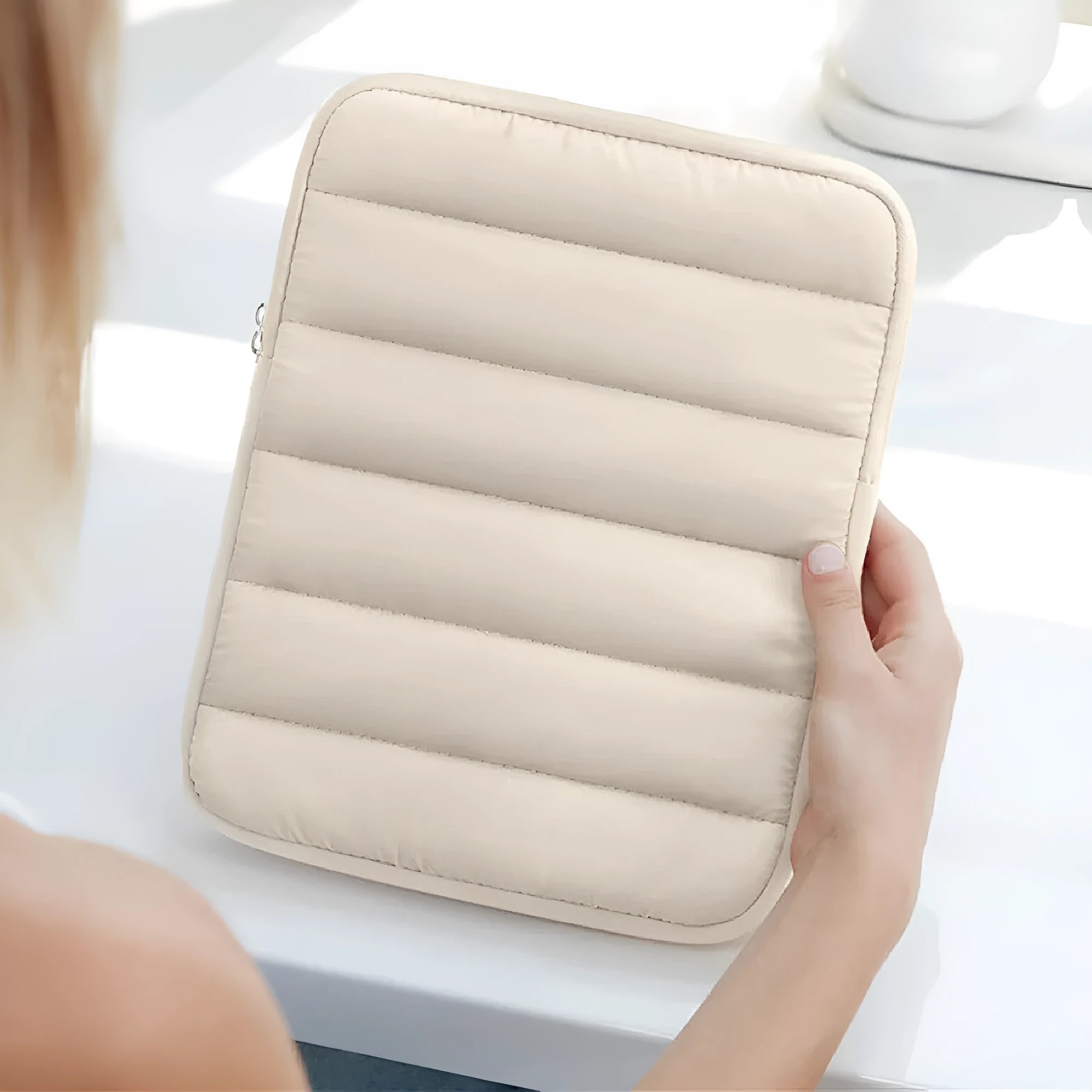 Fluffy black laptop sleeve puff bag with elastic closure for a 9.7 to 11 inch device.