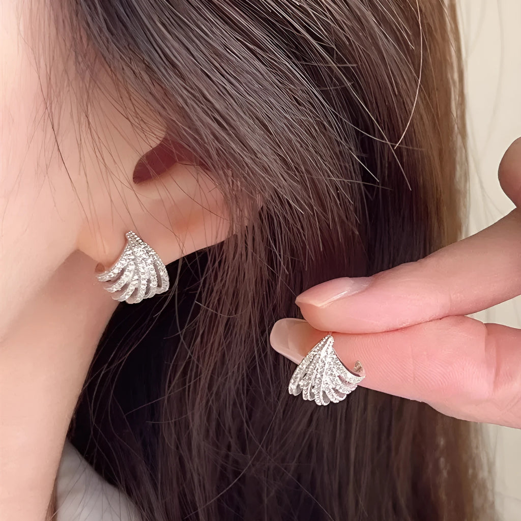 A pair of platinum-coloured geometric line design zircon earrings.