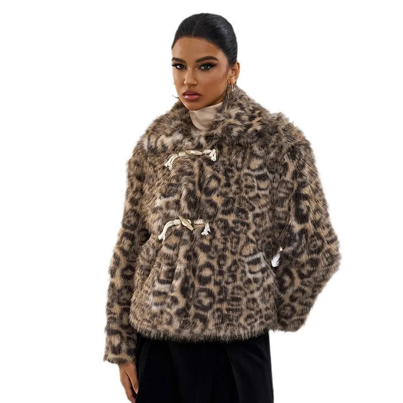 Women's leopard print coat with a buckle lapel, shown in street fashion style.
