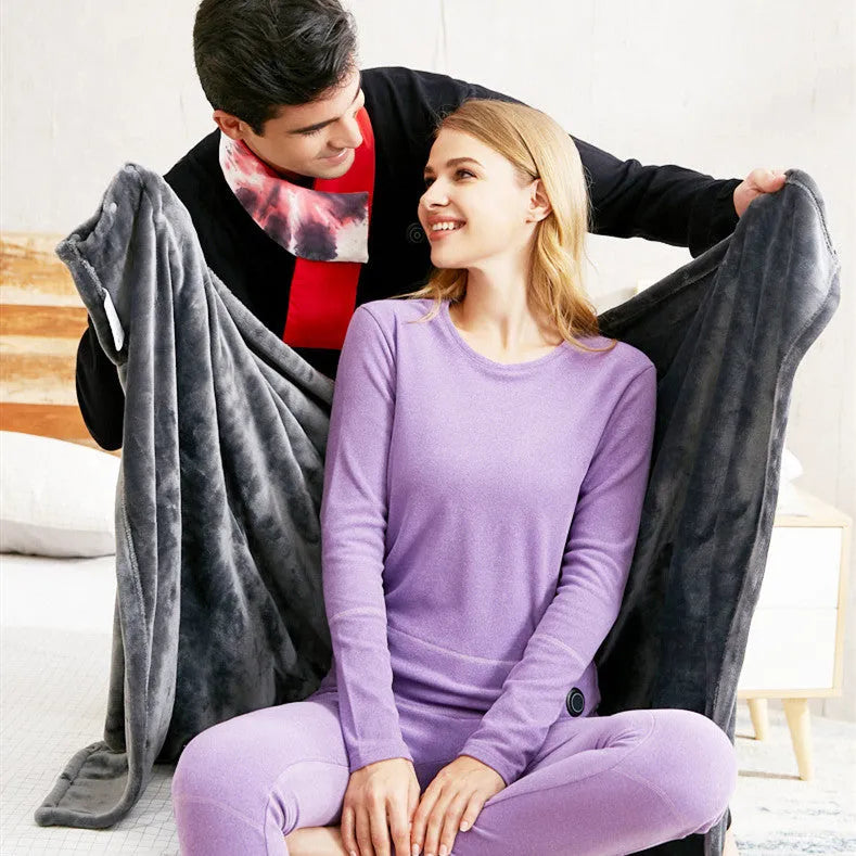 Dark grey USB heated blanket made of coral fleece with 8 carbon fibre heating sheets, 150x85cm size, lying flat on a surface