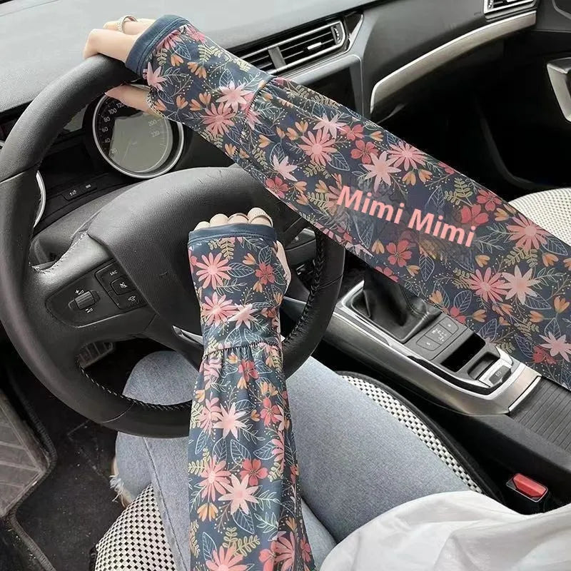 A pair of printed ice silk sun protection sleeves laid flat, showing a floral pattern design.