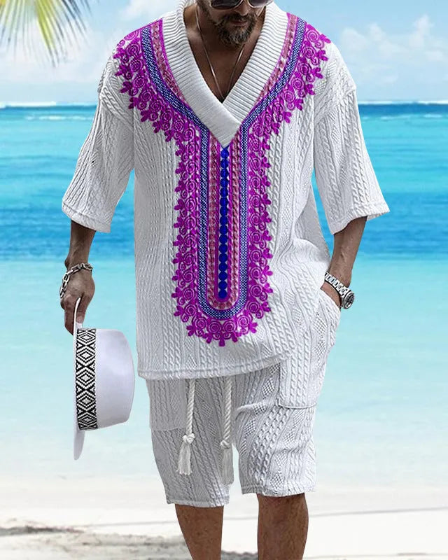 Man wearing a light blue printed drop-shoulder knitted top with matching shorts from a casual summer suit.