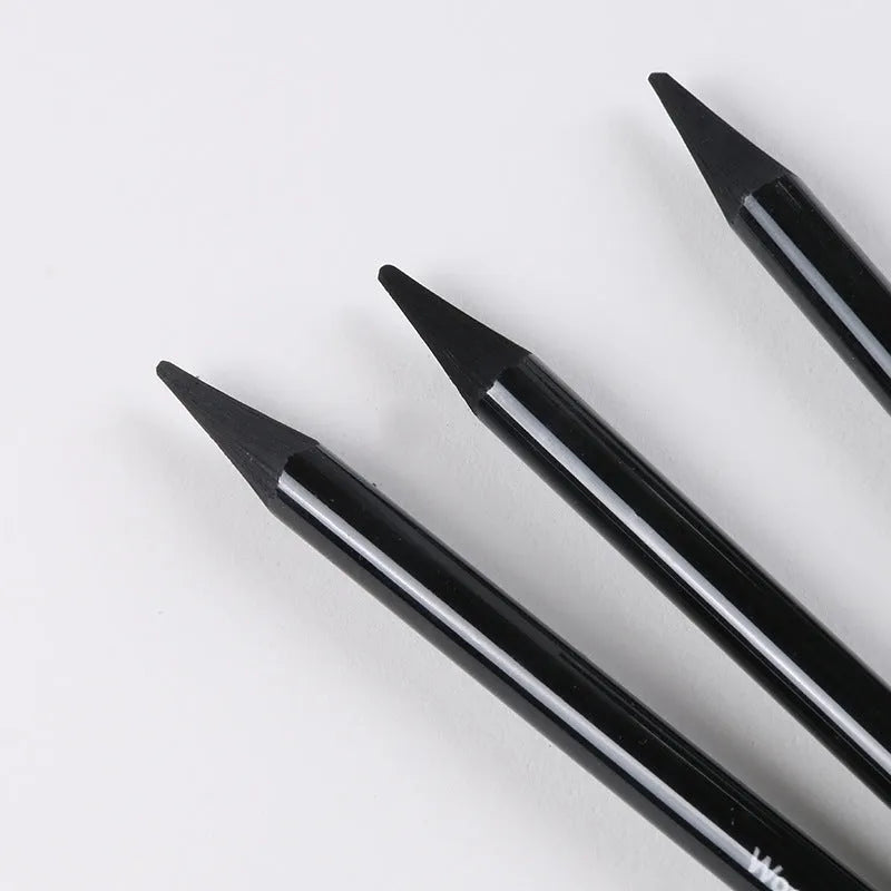 Set of graphite and carbonized wooden pencils on a suction card packaging.