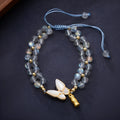 Gray moonstone woven bracelet with geometric design on woven hand rope