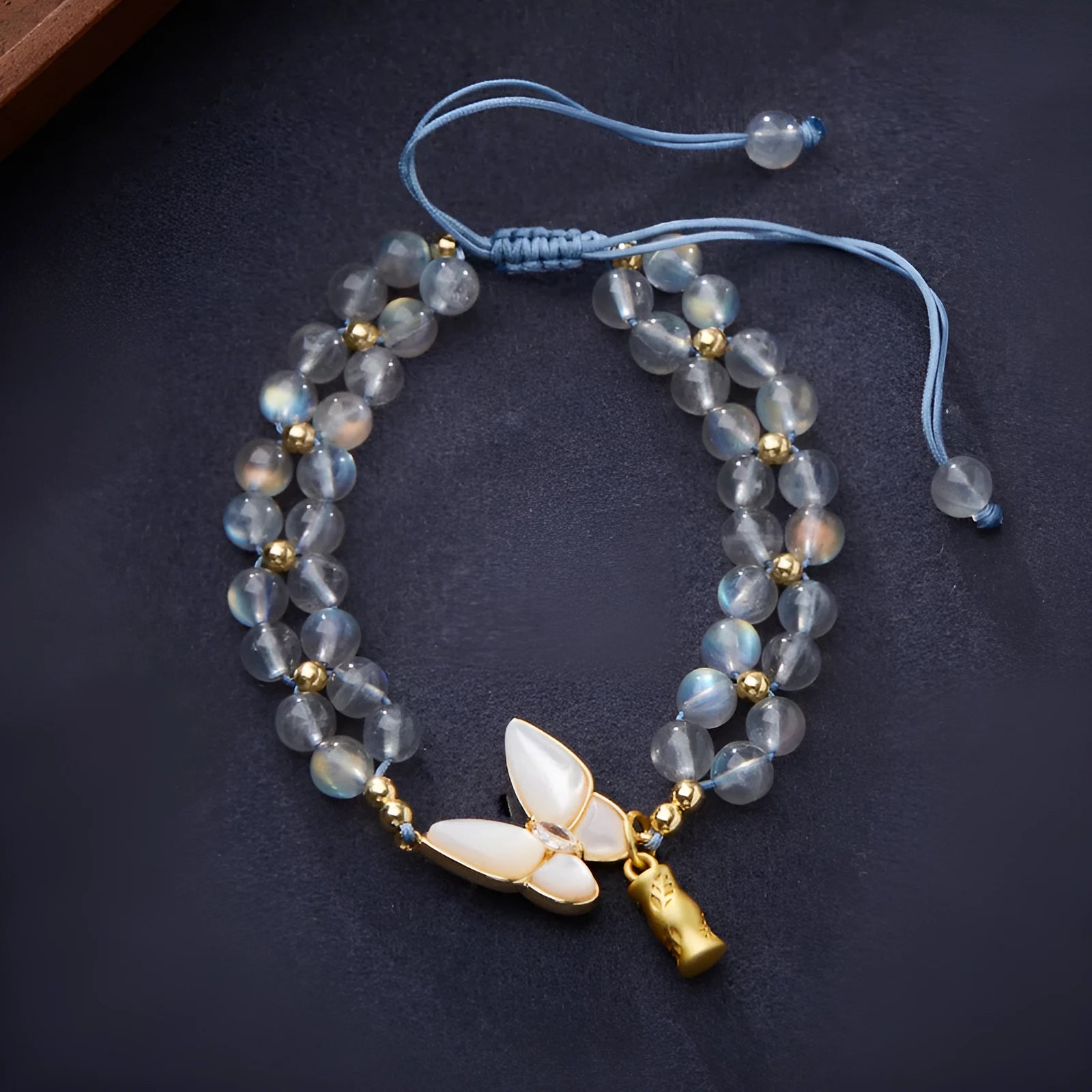 Gray moonstone woven bracelet with geometric design on woven hand rope