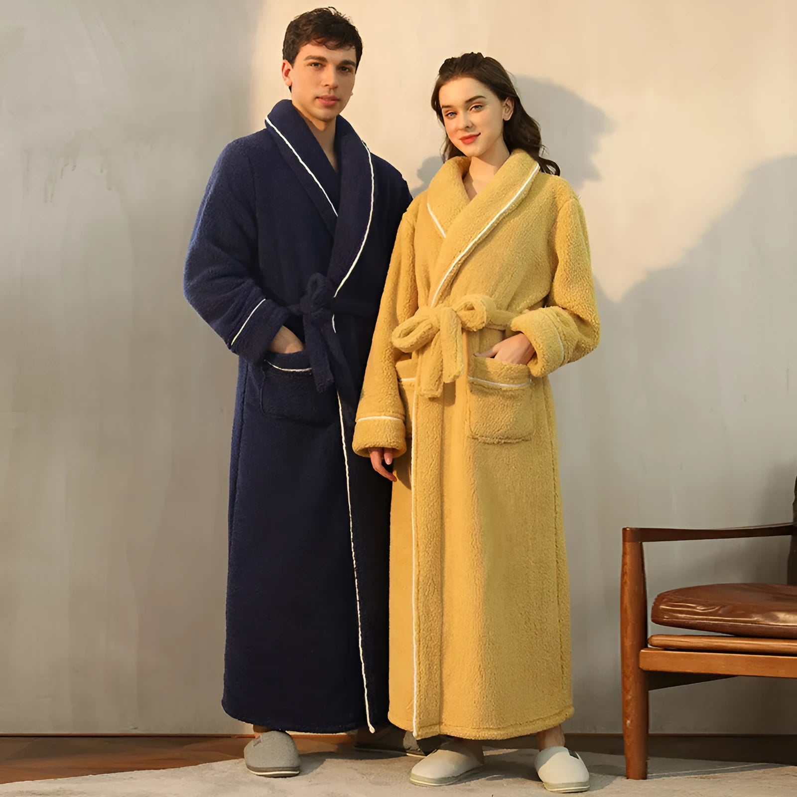 Man and woman wearing matching thick flannel bathrobes in winter colours like navy blue and cherry yellow.