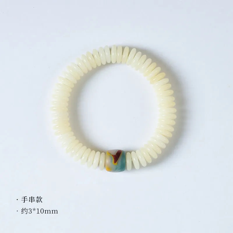 A white Bodhi seed bracelet shown in both a looped wrist style and a straight handheld style.