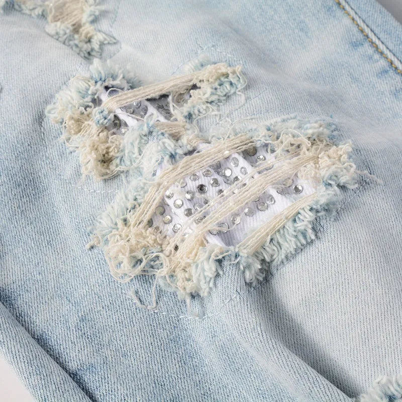 Light blue slim fit stretch men's jeans with distressed details and diamond patch pocket
