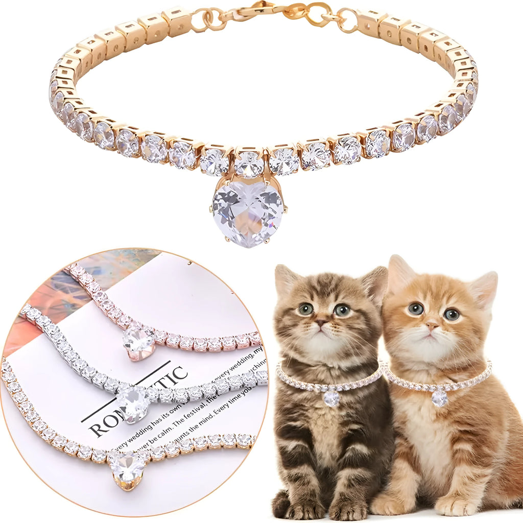Gold heart-shaped rhinestone dog collar on a white background, showing shiny bling design.