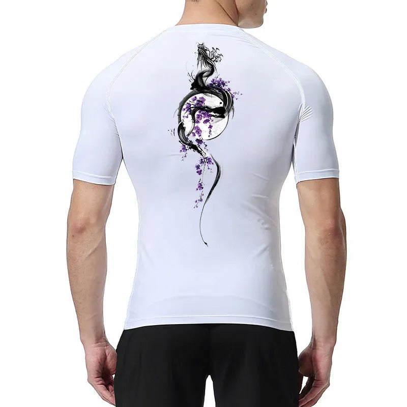 Man wearing a printed short sleeve loose-fit compression shirt in a solid colour background.