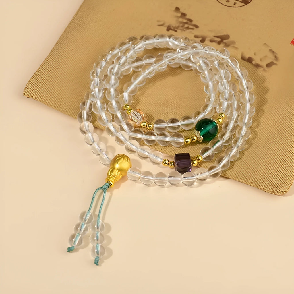 White crystal 108 bead geometric ethnic style bracelet necklace shown worn as both bracelet and necklace
