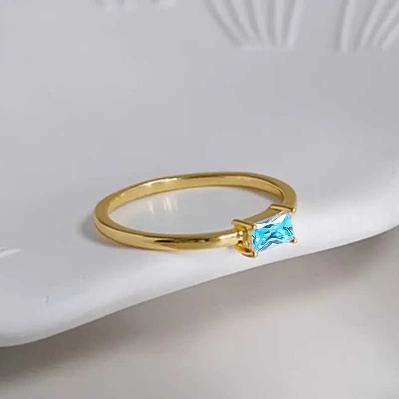 Sapphire blue geometric bracelet ring with zircon stones and heart-shaped elements on copper