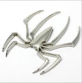 Three-dimensional metal spider bumper sticker in zinc alloy, showing gold, silver, black, and red colour options.