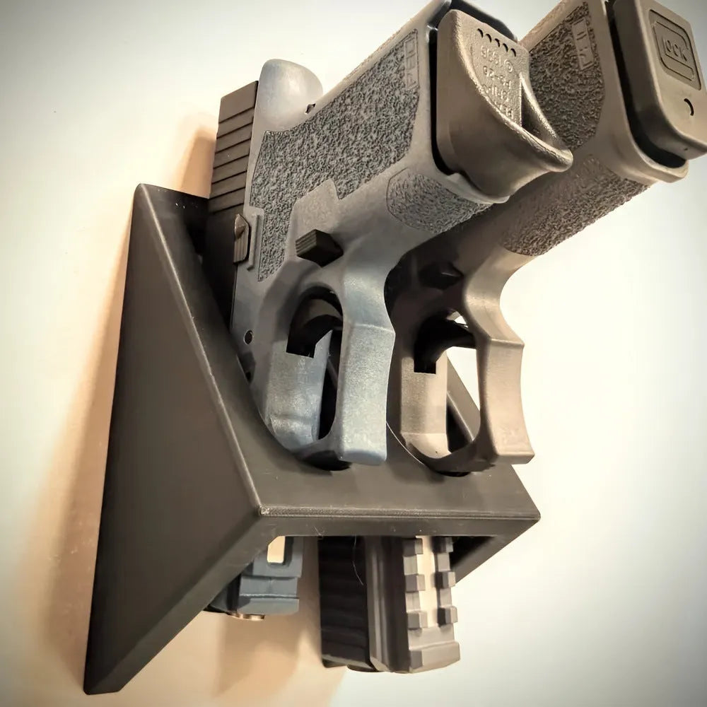 Black plastic pistol display stand for replica and collectable firearms.
