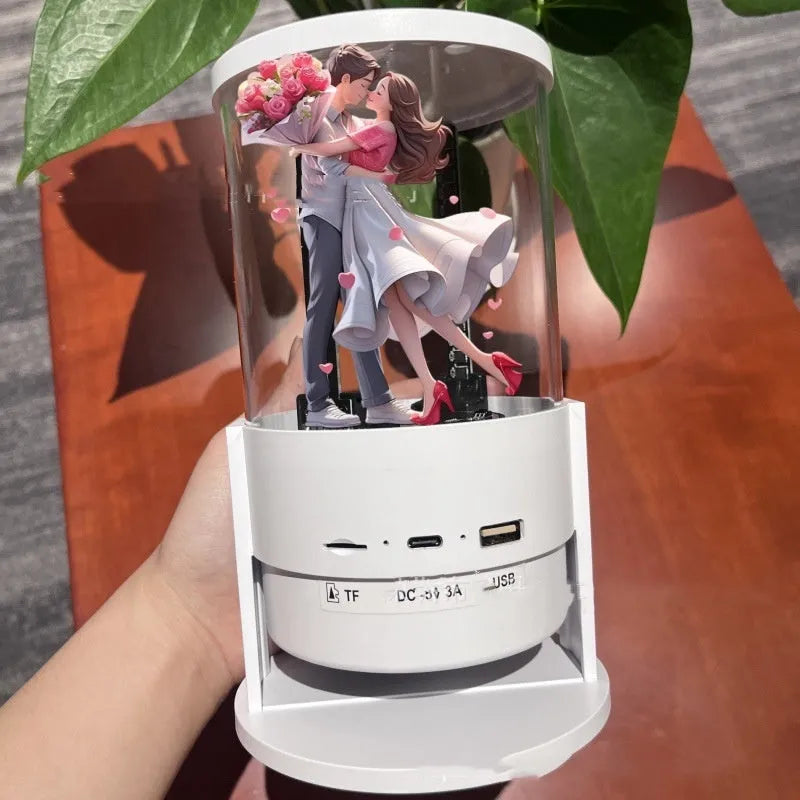 White 360-degree 3D holographic fan Bluetooth speaker with cylindrical screen on a desk