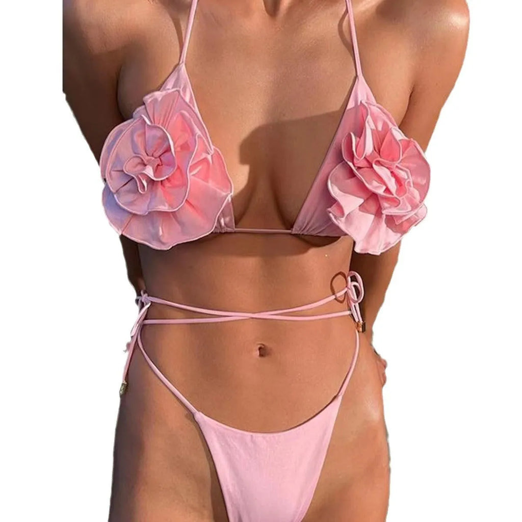Pink halter lace-up three-dimensional flower bikini set on female model, backless brief style for swimming