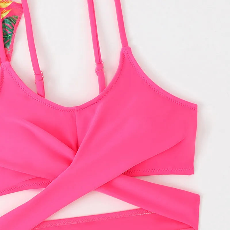 Girls floral print bikini swimsuit on hanger, showing two-piece design and overlay detail.