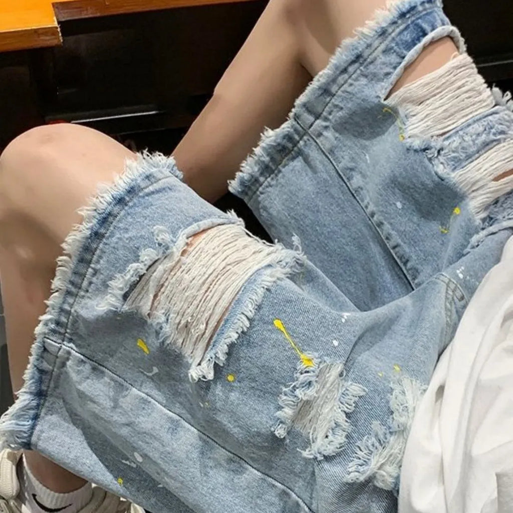 Men's loose fit light blue denim shorts with water washed hole design and fifth pants length.