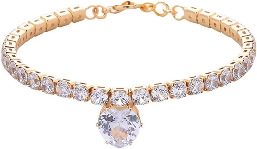 Gold heart-shaped rhinestone dog collar on a white background, showing shiny bling design.